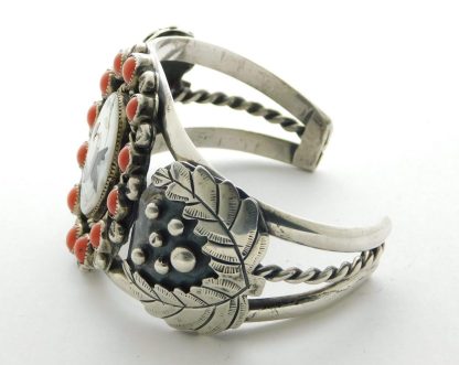 Side view of LEROY DAYEA Navajo Coral and Sterling Silver Bracelet with Zuni Inlay Hummingbird Center