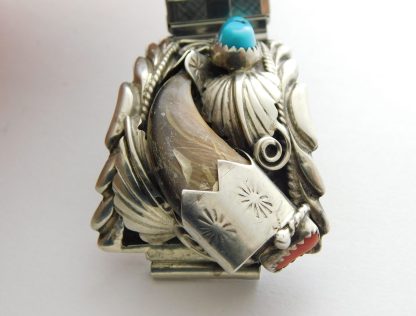 Close-up view of James Toadlena Navajo Bear Claw, Turquoise, and Coral Watchband