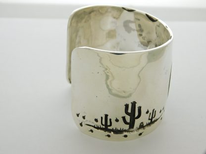 Side view of James Fendenheim Tohono O'odham "The Man-in-the-Maze is Rising" Sterling Silver bracelet