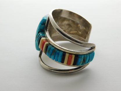 Side view of Pete Sierra Navajo Cobblestone Kingman Turquoise, Jet, Mastodon, and Coral Sterling Silver Bracelet