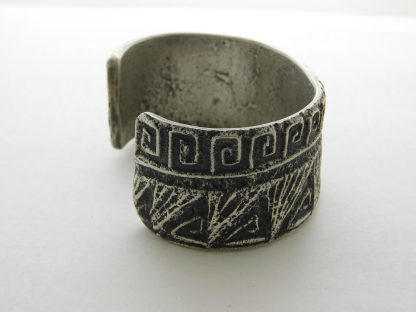 Side view of Stewart Billie Navajo Tufa Cast Silver Bracelet